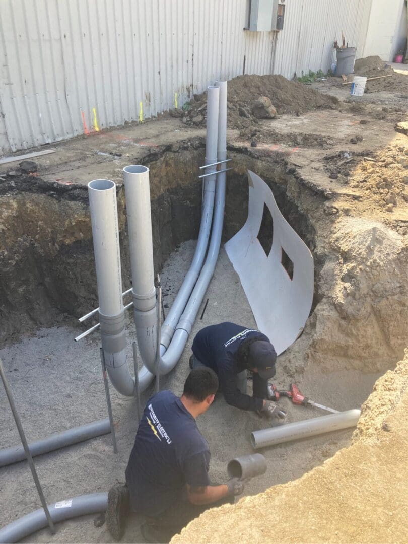 A man working on pipes in the ground.